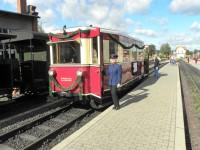 Foto im Bahnhof Gernrode mit Triebwagen und einer Eisenbahnfreundin in alter Uniform